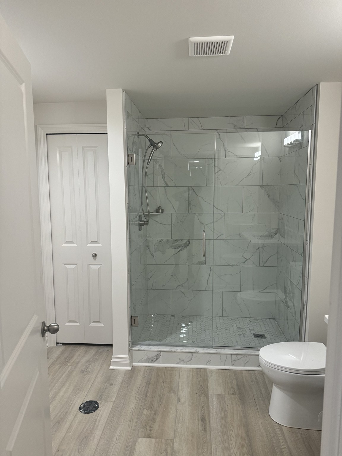 Finished basement bathroom with glass shower enclosure